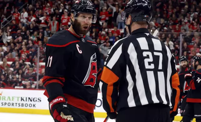 Carolina Hurricanes' Jordan Staal (11) talks with an official about a call during the first period of Game 1 of the NHL hockey Stanley Cup Eastern Conference finals against the Florida Panthers in Raleigh, N.C., Tuesday, May 20, 2025. (AP Photo/Karl DeBlaker)