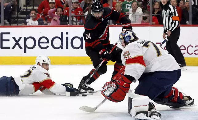Carolina Hurricanes' Seth Jarvis (24) is prevented from shooting the puck by Florida Panthers' Gustav Forsling (42) as goaltender Sergei Bobrovsky (72) looks on during the second period of Game 2 of the NHL hockey Stanley Cup Eastern Conference finals in Raleigh, N.C., Thursday, May 22, 2025. (AP Photo/Karl DeBlaker)