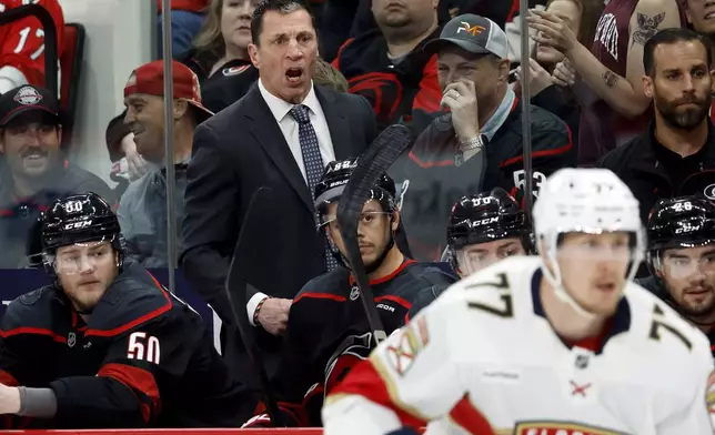 Carolina Hurricanes head coach Rod Brind'Amour watches from the bench during the first period of Game 1 of the NHL hockey Stanley Cup Eastern Conference finals against the Florida Panthers in Raleigh, N.C., Tuesday, May 20, 2025. (AP Photo/Karl DeBlaker)