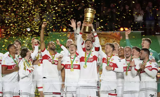VfB Stuttgart players celebrate after winning the trophy in the German soccer cup, DFB Pokal, final match between Arminia Bielefeld and VfB Stuttgart at Olympiastadion in Berlin, Germany, Saturday, May 24, 2025. (AP Photo/Matthias Schrader)