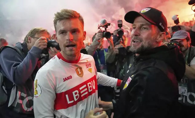 Stuttgart's head coach Sebastian Hoeness, right, and Stuttgart's Maximilian Mittelstaedt celebrate after winning the trophy in the German soccer cup, DFB Pokal, final match between Arminia Bielefeld and VfB Stuttgart at Olympiastadion in Berlin, Germany, Saturday, May 24, 2025. (AP Photo/Matthias Schrader)
