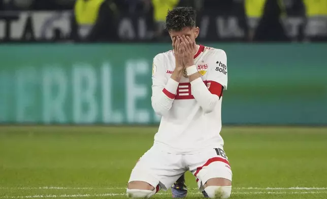 Stuttgart's Atakan Karazor celebrates after winning the trophy in the German soccer cup, DFB Pokal, final match between Arminia Bielefeld and VfB Stuttgart at Olympiastadion in Berlin, Germany, Saturday, May 24, 2025. (AP Photo/Matthias Schrader)