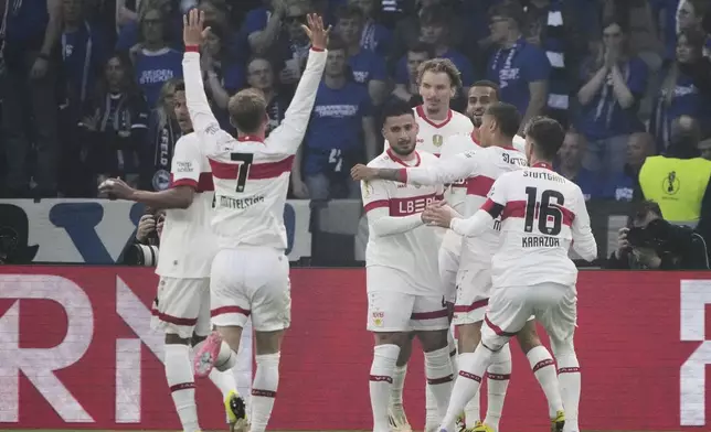 VfB Stuttgart players celebrate after Stuttgart's Deniz Undav, centre, scored his side's third goal during the German soccer cup, DFB Pokal, final match between Arminia Bielefeld and VfB Stuttgart at Olympiastadion in Berlin, Germany, Saturday, May 24, 2025. (AP Photo/Matthias Schrader)