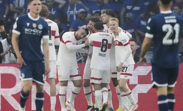 VfB Stuttgart players celebrate after Stuttgart's Deniz Undav, centre, scored his side's third goal during the German soccer cup, DFB Pokal, final match between Arminia Bielefeld and VfB Stuttgart at Olympiastadion in Berlin, Germany, Saturday, May 24, 2025. (AP Photo/Matthias Schrader)