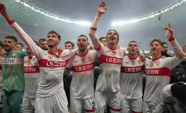 VfB Stuttgart players celebrate after winning the trophy in the German soccer cup, DFB Pokal, final match between Arminia Bielefeld and VfB Stuttgart at Olympiastadion in Berlin, Germany, Saturday, May 24, 2025. (AP Photo/Matthias Schrader)