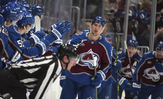 Colorado Avalanche center Martin Necas, center, is congratulated as he passes the team box after scoring in the second period of Game 6 of an NHL hockey first-round playoff series against the Colorado Avalanche, Thursday, May 1, 2025, in Denver. (AP Photo/David Zalubowski)