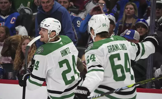 Dallas Stars center Roope Hintz, left, celebrates after scoring with center Mikael Granlund in the second period of Game 6 of an NHL hockey first-round playoff series against the Colorado Avalanche, Thursday, May 1, 2025, in Denver. (AP Photo/David Zalubowski)