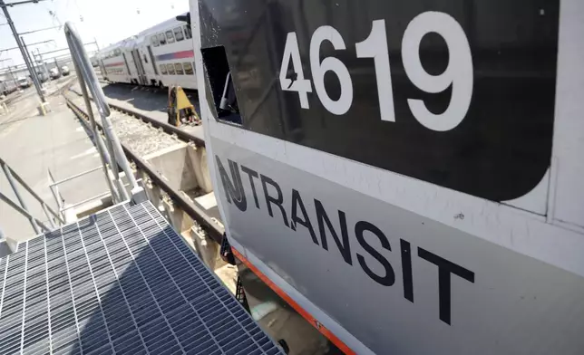 FILE - A train is seen on a maintenance track at New Jersey Transit's Meadows Maintenance Complex, Tuesday, May 1, 2018, in Kearny, N.J. (AP Photo/Julio Cortez, File)