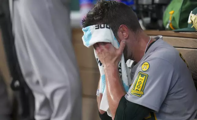 Oakland Athletics starting pitcher Jeffrey Springs wipes his face after pitching to the Texas Rangers during the fourth inning of a baseball game Thursday, May 1, 2025, in Arlington, TX. (AP Photo/Julio Cortez)