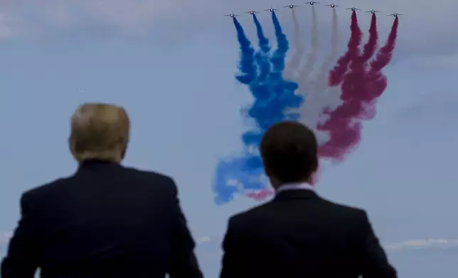 FILE - President Donald Trump, left, and French President Emmanuel Macron watch a flyover during a ceremony to commemorate the 75th anniversary of D-Day at the American Normandy cemetery, June 6, 2019, in Colleville-sur-Mer, Normandy, France. (AP Photo/Alex Brandon, File)