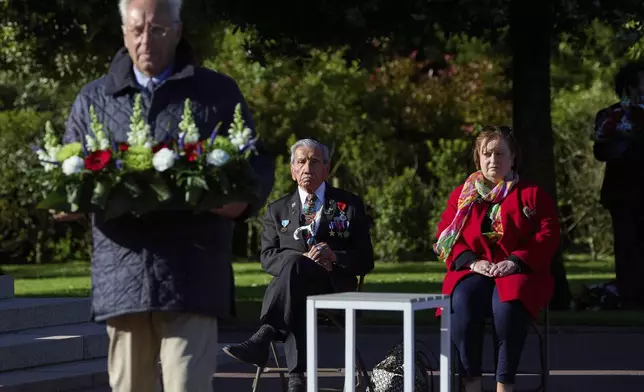 World War II D-Day veteran and Penobscot Elder from Maine, Charles Norman Shay, center, and Marie Pacale Legrand during a D-Day 76th anniversary ceremony at the Normandy American Cemetery in Colleville-sur-Mer, Normandy, France, June 6, 2020. (AP Photo/Virginia Mayo)