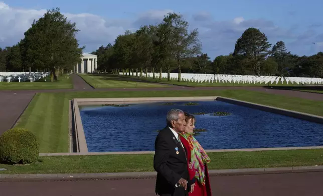 FILE - World War II D-Day veteran and Penobscot Elder from Maine, Charles Norman Shay, left, and Marie Pacale Legrand walk by graves during a D-Day 76th anniversary ceremony at the Normandy American Cemetery in Colleville-sur-Mer, Normandy, France, June 6, 2020. (AP Photo/Virginia Mayo)