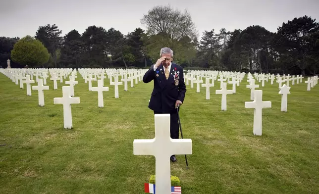 FILE - World War II and D-Day veteran Charles Norman Shay, from Indian Island, Maine, salutes the grave of fellow soldier Edward Morozewicz at the Normandy American Cemetery in Colleville-sur-Mer, Normandy, France, May 1, 2019. (AP Photo/Virginia Mayo, File)