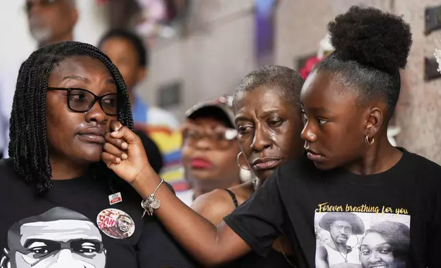 Family members of George Floyd, from left, Bianca Williams, Zsa Zsa Floyd, and Arianna Williams, 7, react during a memorial service on the anniversary of Floyd's death on Sunday, May 25, 2025, in Houston. (AP Photo/Ashley Landis)