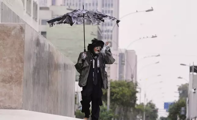 A clown walks to take part in National Clown Day celebrations in Lima, Peru, Sunday, May 25, 2025. (AP Photo/Martin Mejia)