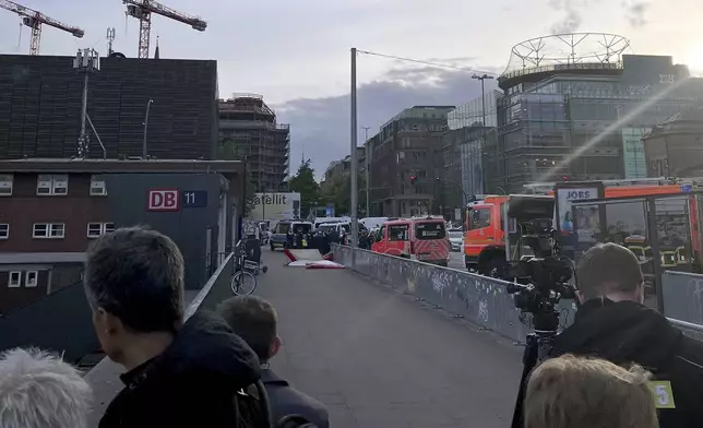 Emergency services at the scene of a stabbing at Hamburg Central Station in Hamburg, Germany, Friday, May 23, 2025. (Lukas Mueller/dpa via AP)