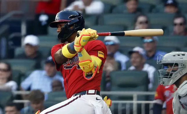 Atlanta Braves' Ronald Acuña Jr. hits a single during the first inning of a baseball game against the Boston Red Sox, Friday, May 30, 2025, in Atlanta. (AP Photo/Butch Dill)