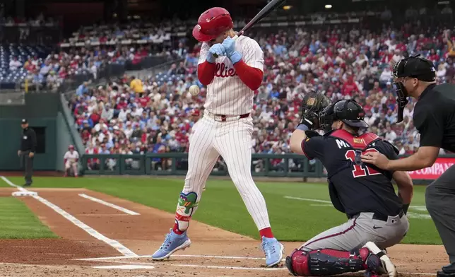 Philadelphia Phillies' Bryce Harper is hit by a pitch from Atlanta Braves' Spencer Strider during the first inning of a baseball game Tuesday, May 27, 2025, in Philadelphia. (AP Photo/Matt Slocum)