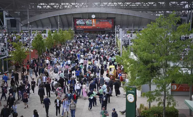 People walk along the Roland-Garros stadium, in Paris, Wednesday, May 28, 2025. (AP Photo/Aurelien Morissard)