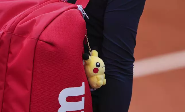 China's Guo Hanyu's carries her bag before playing Britain's Jodie Burrage and Sonny Kartal during their match of the French Tennis Open, at the Roland-Garros stadium, in Paris, Wednesday, May 28, 2025. (AP Photo/Lindsey Wasson)
