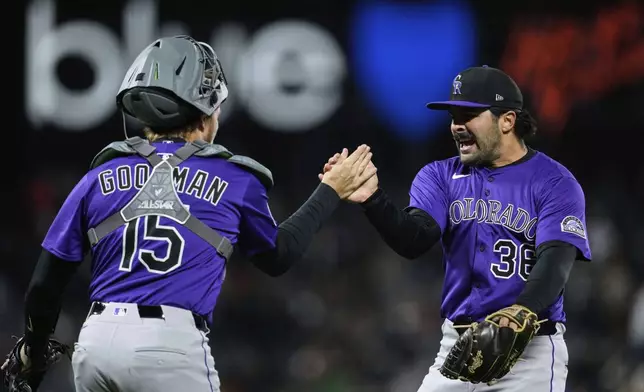 Colorado Rockies pitcher Zach Agnos, right, and catcher Hunter Goodman celebrate after the team's victory over the San Francisco Giants in a baseball game Thursday, May 1, 2025, in San Francisco. (AP Photo/Godofredo A. Vásquez)