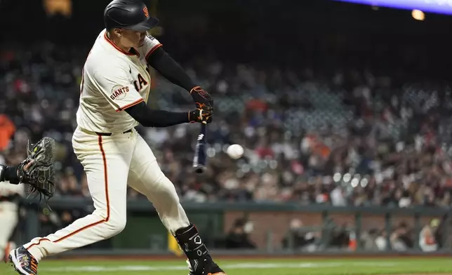 San Francisco Giants' Wilmer Flores hits an RBI double during the sixth inning of a baseball game against the Colorado Rockies, Thursday, May 1, 2025, in San Francisco. (AP Photo/Godofredo A. Vásquez)