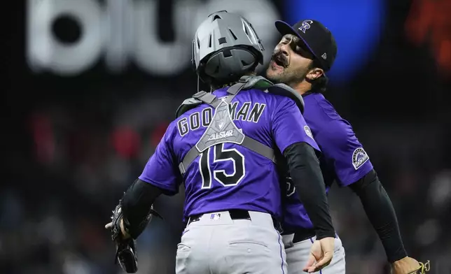 Colorado Rockies pitcher Zach Agnos, right, and catcher Hunter Goodman celebrate after the team's victory over the San Francisco Giants in a baseball game Thursday, May 1, 2025, in San Francisco. (AP Photo/Godofredo A. Vásquez)