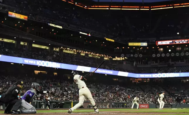 San Francisco Giants' Mike Yastrzemski (5) hits an RBI double during the sixth inning of a baseball game against the Colorado Rockies, Thursday, May 1, 2025, in San Francisco. (AP Photo/Godofredo A. Vásquez)