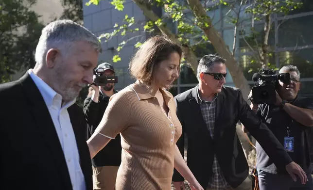 Anamaria Baralt, center, a cousin of Erik and Lyle Menendez, who were convicted of killing their parents in 1989, arrives to court Friday, May 9, 2025, in Los Angeles. (AP Photo/Jae C. Hong)