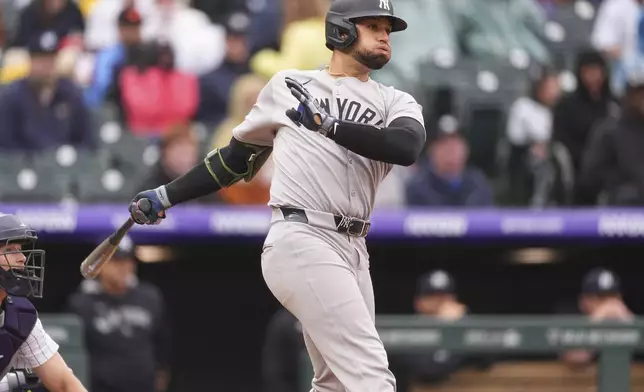 New York Yankees' J.C. Escarra follows the flight of his RBI single off Colorado Rockies relief pitcher Tyler Kinley in the eighth inning of a baseball game Sunday, May 25, 2025, in Denver. (AP Photo/David Zalubowski)