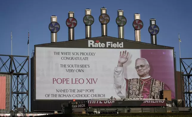 The Chicago White Sox honors Pope Leo XIV on the scoreboard before a baseball game against the Miami Marlins, Friday, May 8, 2025, in Chicago. (AP Photo/David Banks)