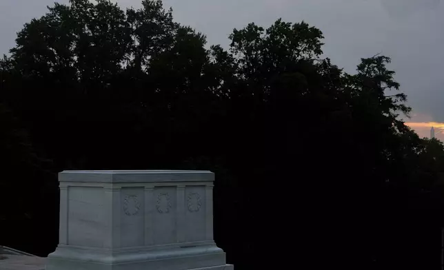 The Washington Monument is visible behind the Tomb of the Unknown Soldier at sunrise, Thursday, May 15, 2025, Arlington National Cemetery in Arlington, Va. (AP Photo/Julia Demaree Nikhinson)