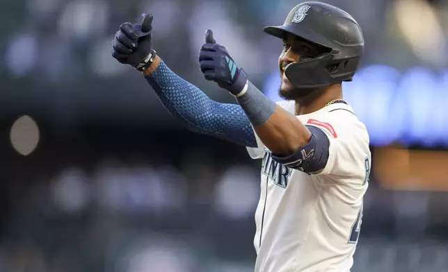 Seattle Mariners' Julio Rodriguez celebrates after hitting a single that scored Ben Williamson during the sixth inning of a baseball game against the Washington Nationals, Tuesday, May 27, 2025, in Seattle. (AP Photo/Ryan Sun)