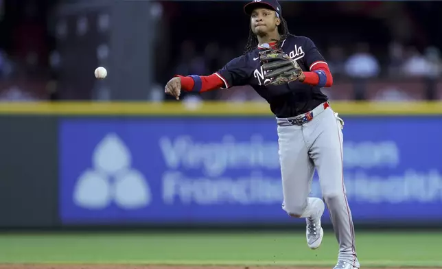 Washington Nationals shortstop CJ Abrams throws out Seattle Mariners J.P. Crawford at first during the sixth inning of a baseball game Tuesday, May 27, 2025, in Seattle. (AP Photo/Ryan Sun)