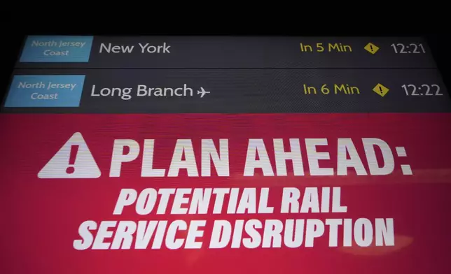 An electronic display advises commuters of potential NJ Transit service disruptions at the Secaucus Junction station in Secaucus, N.J., Wednesday, May 14, 2025. (AP Photo/Seth Wenig)