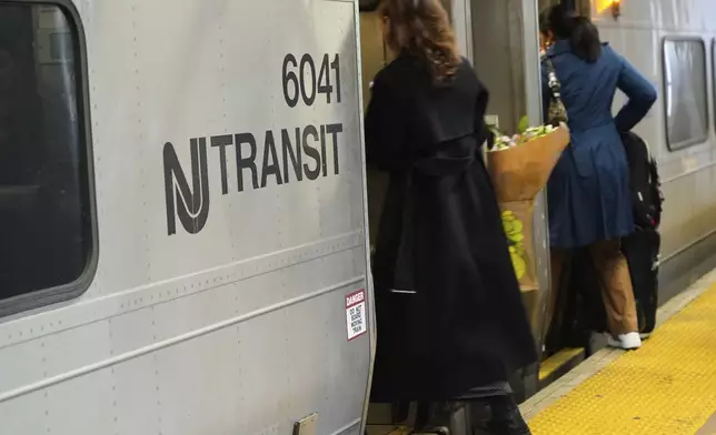 People board an NJ Transit train at the Secaucus Junction station in Secaucus, N.J., Wednesday, May 14, 2025. (AP Photo/Seth Wenig)