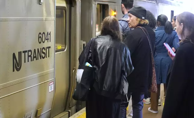 People wait to board an NJ Transit train at the Secaucus Junction station in Secaucus, N.J., Wednesday, May 14, 2025. (AP Photo/Seth Wenig)