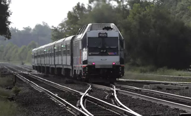 FILE - In this Aug. 3, 2018, file photo, a New Jersey Transit train leaves the Bound Brook Station in Bound Brook, N.J. (AP Photo/Julio Cortez, File)