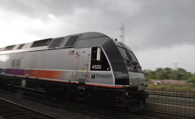 FILE - A New Jersey Transit train leaves the Bound Brook Station, Friday, Aug. 3, 2018, in Bound Brook, N.J. Commuters were faced with many train cancellations during the morning rush hour. (AP Photo/Julio Cortez, File)