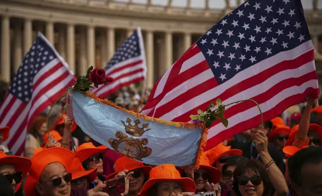 Faithful wave flags from the United States as they wait for Pope Leo XIV to appear at the central balcony of St. Peter's Basilica for his first Sunday blessing after his election, in St. Peter's Square at the Vatican, Sunday, May 11, 2025.(AP Photo/Andrew Medichini)