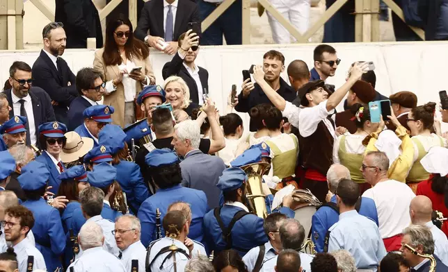 Marine Le Pen stands in the crowd at St. Peter's Square at the Vatican where newly elected Pope Leo XIV delivered his first Sunday blessing from the central balcony of St. Peter's Basilica Sunday, May 11, 2025. (Cecilia Fabiano/LaPresse via AP)