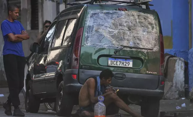 A drug addict smokes crack cocaine in a downtown area popularly known as "Crackland" in Sao Paulo, Tuesday, May 20, 2025. (AP Photo/Andre Penner)