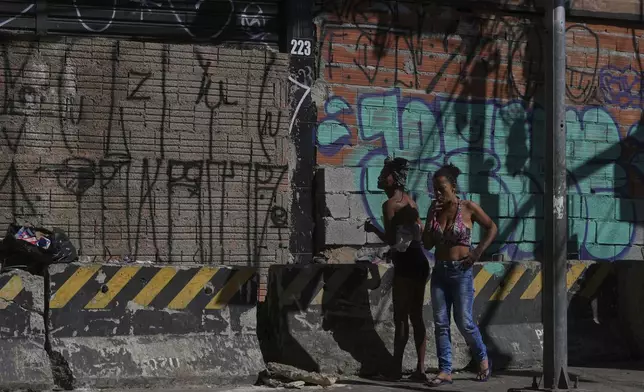 A drug addict smokes crack cocaine in a downtown area popularly known as "Crackland" in Sao Paulo, Tuesday, May 20, 2025. (AP Photo/Andre Penner)
