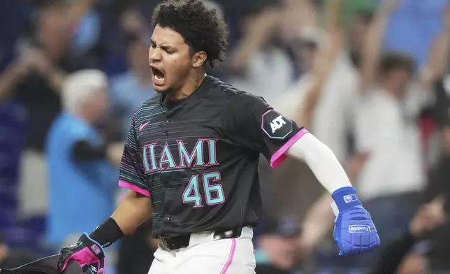 Miami Marlins' Javier Sanoja (46) reacts after scoring on a walk-off grand slam hit by Kyle Stowers during the ninth inning of a baseball game against the Oakland Athletics, Saturday, May 3, 2025, in Miami. (AP Photo/Lynne Sladky)