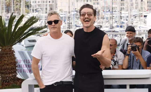 Joaquin Phoenix, left, and Pedro Pascal pose for photographers at the photo call for the film 'Eddington' at the 78th international film festival, Cannes, southern France, Saturday, May 17, 2025. (Photo by Joel C Ryan/Invision/AP)