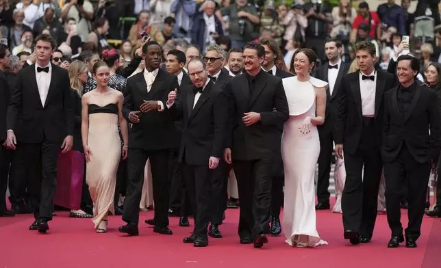 Cameron Mann, from left, Amelie Hoeferle, Micheal Ward, director Ari Aster, Joaquin Phoenix, Emma Stone, Austin Butler and Clifton Collins Jr. pose for photographers upon arrival at the premiere of the film 'Eddington' at the 78th international film festival, Cannes, southern France, Friday, May 16, 2025. (AP Photo/Natacha Pisarenko)