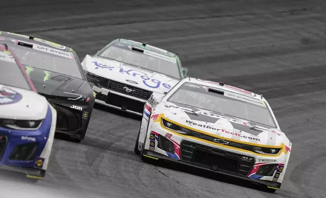 Shane van Gisbergen (88) passes Ty Gibbs in Turn 4 during a NASCAR Cup Series auto race at Charlotte Motor Speedway, Sunday, May 25, 2025, in Concord, N.C. (AP Photo/Matt Kelley)