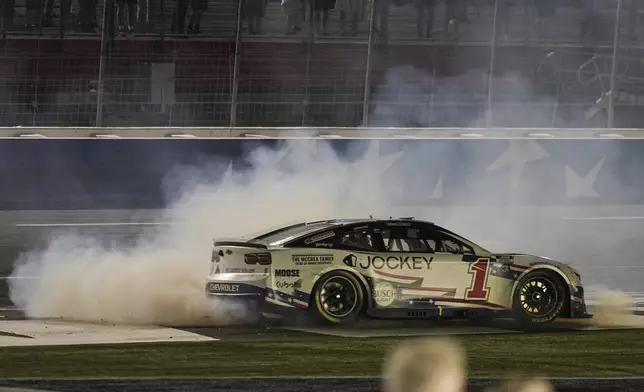Ross Chastain does a burnout after winning a NASCAR Cup Series auto race at Charlotte Motor Speedway, Sunday, May 25, 2025, in Concord, N.C. (AP Photo/Matt Kelley)