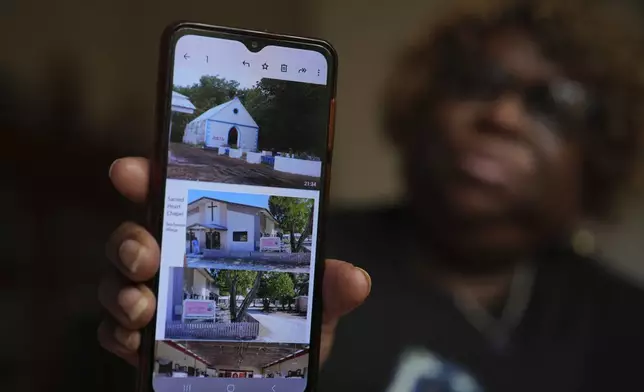 Chagossian Bernadette Dugasse shows photos of a church in the Chagos Islands during an interview with The Associated Press, at her home in London, Tuesday, March 25, 2025. (AP Photo/Kin Cheung)