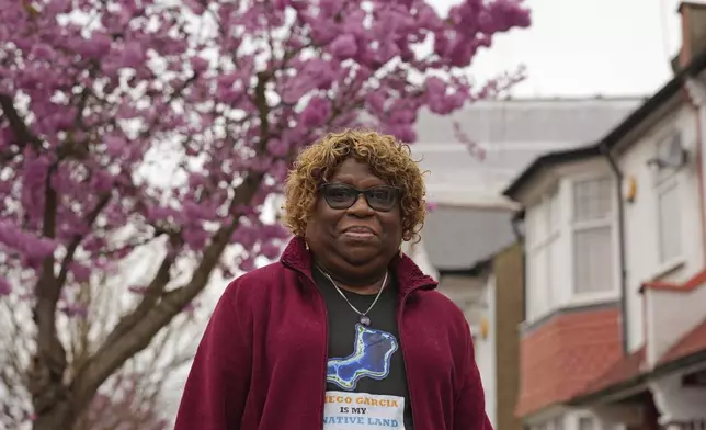 Chagossian Bernadette Dugasse poses for a photograph outside her home in London, Tuesday, March 25, 2025. (AP Photo/Kin Cheung)
